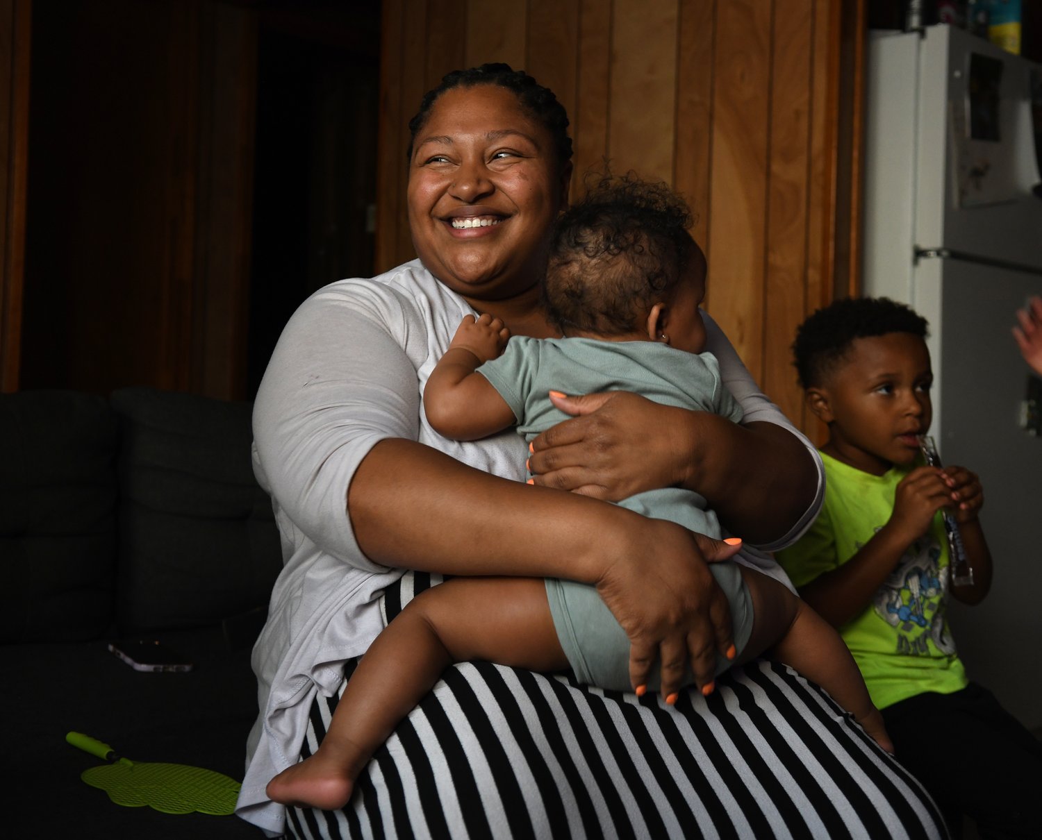 Alexis Ratliff, 29, with her 11-month-old daughter Eleah Witcher and son Ezekiel, 5, in their Rocky Mount home recently. Ratliff had a doula to help with the birth of Eleah. (Natalee Waters)
